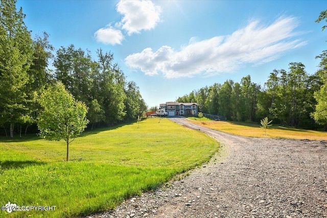 3872 N Charley Dr, Wasilla, AK 99654 - view of community featuring gravel driveway, a lawn, and a rural view