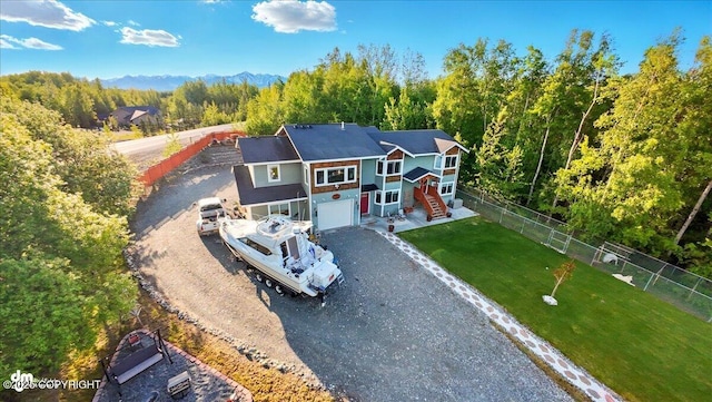 3872 N Charley Dr, Wasilla, AK 99654 - view of front of property with dirt driveway, an attached garage, a view of trees, and stairs