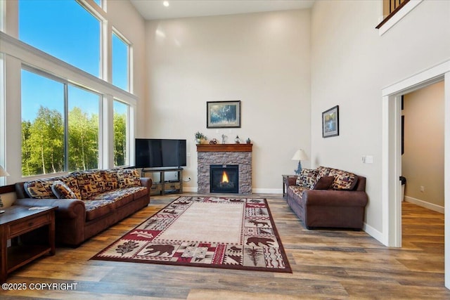 2034 E Sage Rd, Wasilla, AK 99654 - living area with a towering ceiling, wood finished floors, baseboards, a fireplace, and recessed lighting