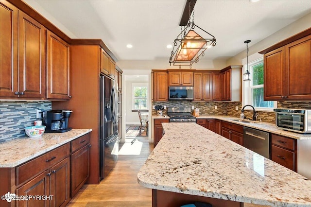 2034 E Sage Rd, Wasilla, AK 99654 - kitchen with stainless steel appliances, recessed lighting, tasteful backsplash, a sink, and a center island