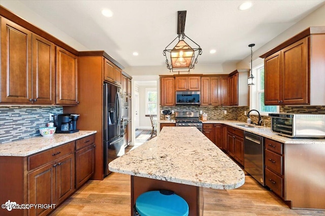 2034 E Sage Rd, Wasilla, AK 99654 - kitchen featuring stainless steel appliances, a sink, tasteful backsplash, a kitchen island, and recessed lighting