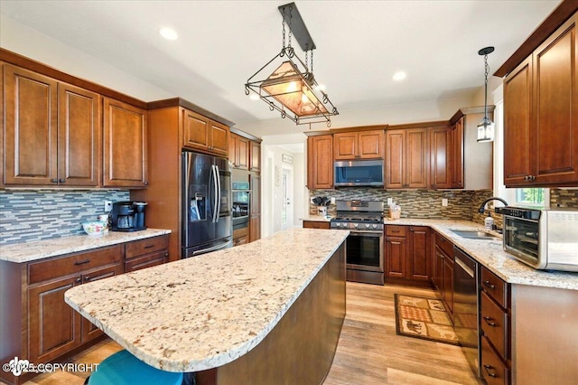 2034 E Sage Rd, Wasilla, AK 99654 - kitchen featuring appliances with stainless steel finishes, a sink, backsplash, light wood finished floors, and recessed lighting