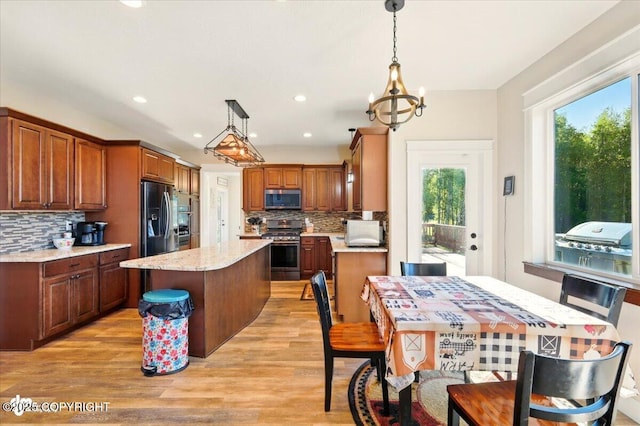 2034 E Sage Rd, Wasilla, AK 99654 - kitchen featuring stainless steel appliances, a center island, plenty of natural light, backsplash, and recessed lighting