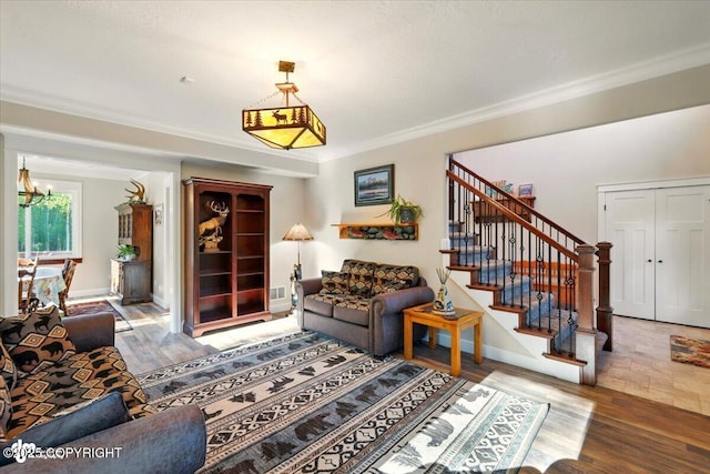 2034 E Sage Rd, Wasilla, AK 99654 - living area featuring stairs, wood finished floors, a chandelier, crown molding, and baseboards