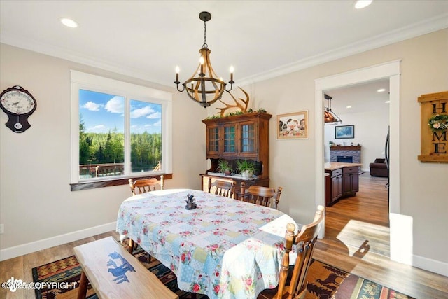 2034 E Sage Rd, Wasilla, AK 99654 - dining space featuring a chandelier, light wood-style floors, ornamental molding, recessed lighting, and baseboards