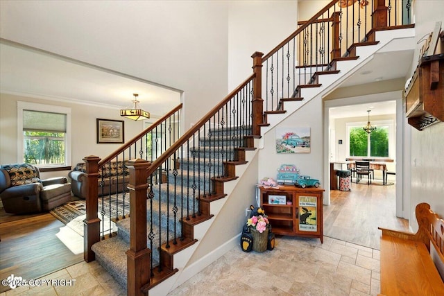 2034 E Sage Rd, Wasilla, AK 99654 - stairs with plenty of natural light, baseboards, a towering ceiling, and stone finish floors