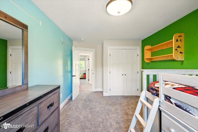 2034 E Sage Rd, Wasilla, AK 99654 - carpeted bedroom with a closet, baseboards, and a textured ceiling