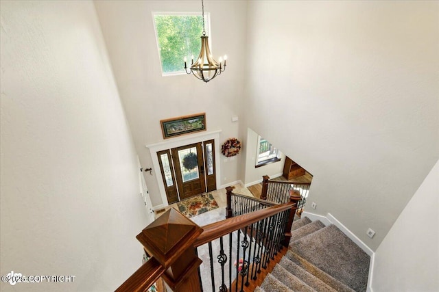 2034 E Sage Rd, Wasilla, AK 99654 - stairs featuring a chandelier, baseboards, and a high ceiling