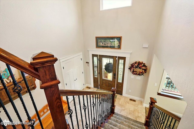 2034 E Sage Rd, Wasilla, AK 99654 - entryway featuring a towering ceiling, stairs, healthy amount of natural light, and baseboards