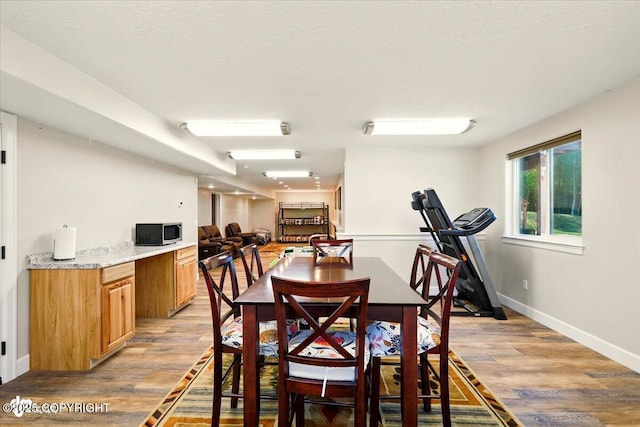2034 E Sage Rd, Wasilla, AK 99654 - dining space featuring light wood-style flooring and baseboards