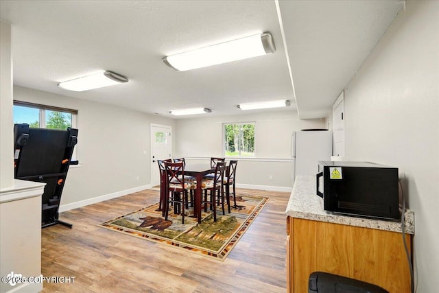 2034 E Sage Rd, Wasilla, AK 99654 - dining area with light wood finished floors, plenty of natural light, and baseboards
