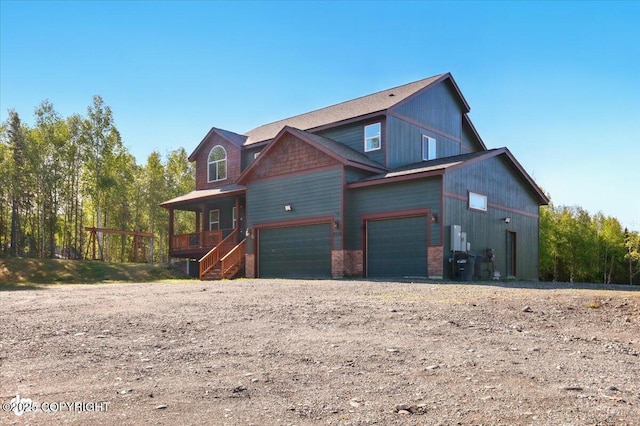 2034 E Sage Rd, Wasilla, AK 99654 - view of side of home featuring an attached garage, dirt driveway, and a porch