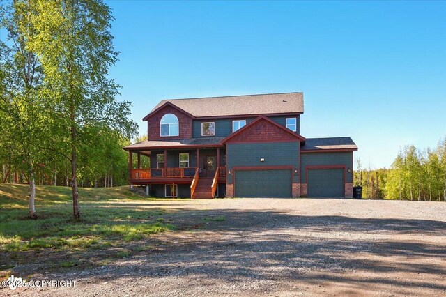 2034 E Sage Rd, Wasilla, AK 99654 - chalet / cabin with gravel driveway, an attached garage, and a porch