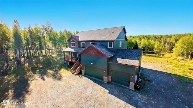 2034 E Sage Rd, Wasilla, AK 99654 - view of front of property with driveway, a wooden deck, and a wooded view