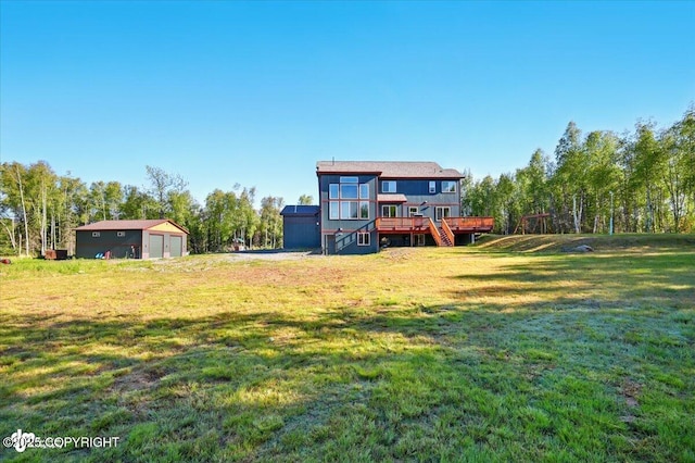 2034 E Sage Rd, Wasilla, AK 99654 - view of grassy yard with a deck, a garage, and stairway
