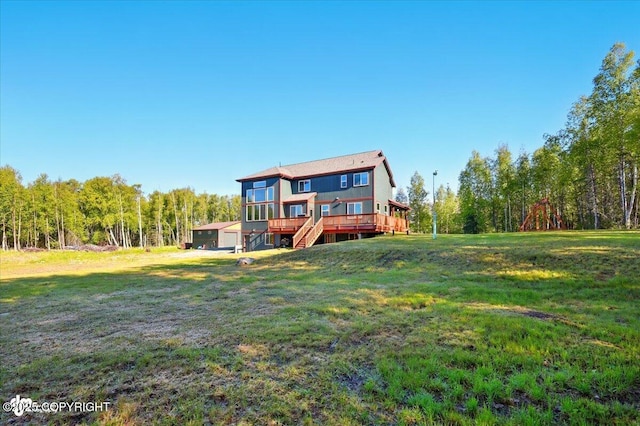 2034 E Sage Rd, Wasilla, AK 99654 - rear view of house featuring a wooden deck, a yard, a view of trees, and stairs