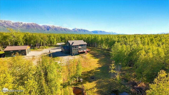 2034 E Sage Rd, Wasilla, AK 99654 - aerial view of property and surrounding area featuring a mountainous background and a heavily wooded area