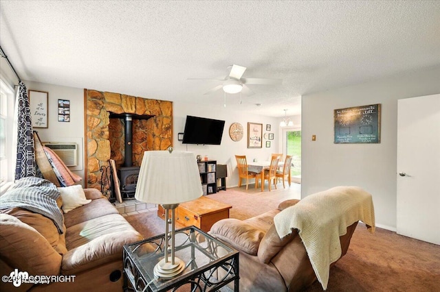751 W Crestwood Ave, Wasilla, AK 99654 - living room with light carpet, ceiling fan, a wood stove, a textured ceiling, and cooling unit