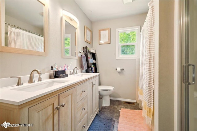 751 W Crestwood Ave, Wasilla, AK 99654 - full bathroom featuring toilet, double vanity, curtained shower, and baseboards