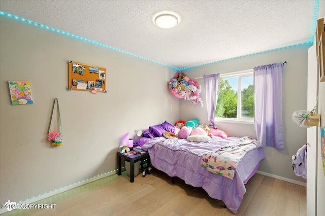 751 W Crestwood Ave, Wasilla, AK 99654 - bedroom featuring wood finished floors and a textured ceiling