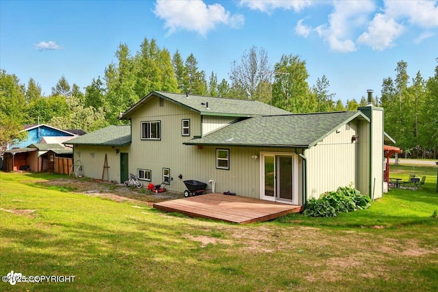 751 W Crestwood Ave, Wasilla, AK 99654 - back of property featuring a deck, roof with shingles, a yard, and a chimney