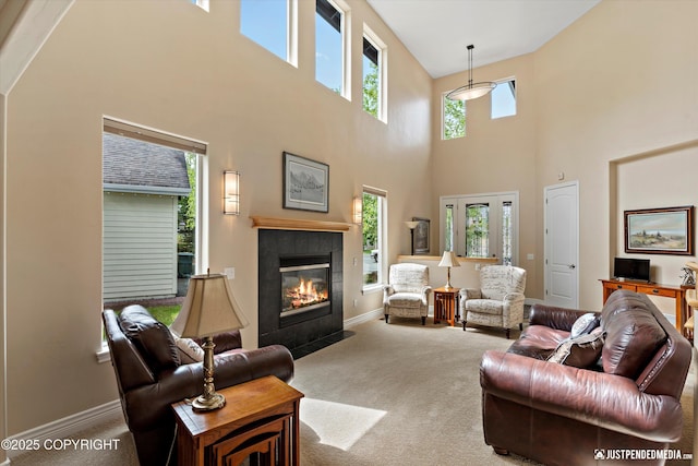 2931 Captain Cook Estates Cir, Anchorage, AK 99517 - carpeted living room with a high ceiling, a tile fireplace, and baseboards