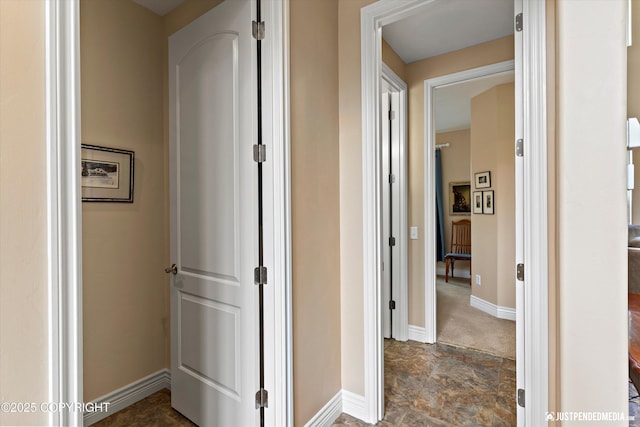 2931 Captain Cook Estates Cir, Anchorage, AK 99517 - corridor with baseboards and stone finish floors
