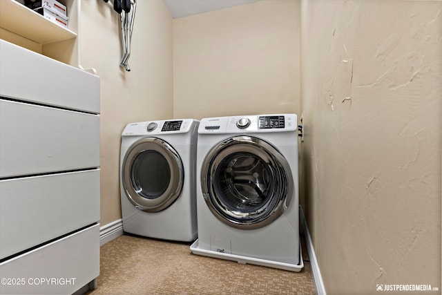 2931 Captain Cook Estates Cir, Anchorage, AK 99517 - laundry room with washer and clothes dryer, carpet floors, and baseboards