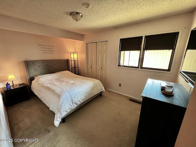 10250 Jamestown Dr # B-09, Anchorage, AK 99507 - bedroom featuring a closet, carpet flooring, a textured ceiling, and baseboards
