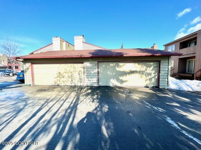 10250 Jamestown Dr # B-09, Anchorage, AK 99507 - view of home's exterior with a chimney