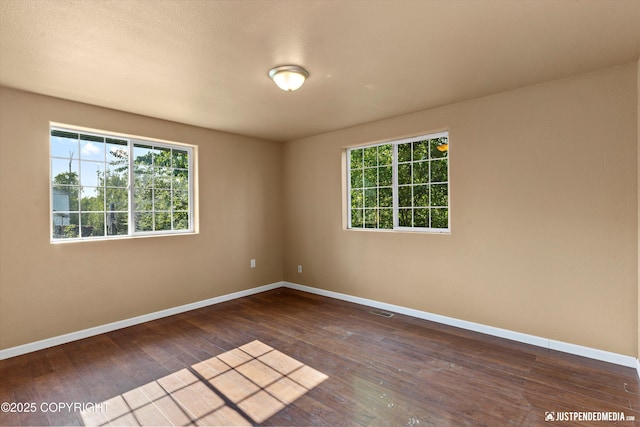 2261 Ridgewood Dr, Wasilla, AK 99654 - unfurnished room with healthy amount of natural light and dark wood-style floors