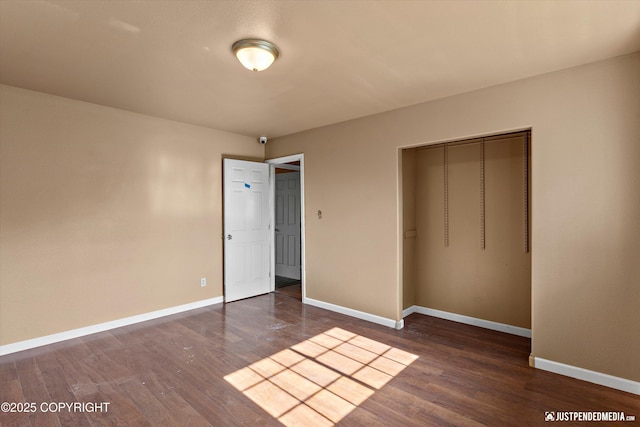2261 Ridgewood Dr, Wasilla, AK 99654 - unfurnished bedroom featuring dark wood-style flooring and a closet