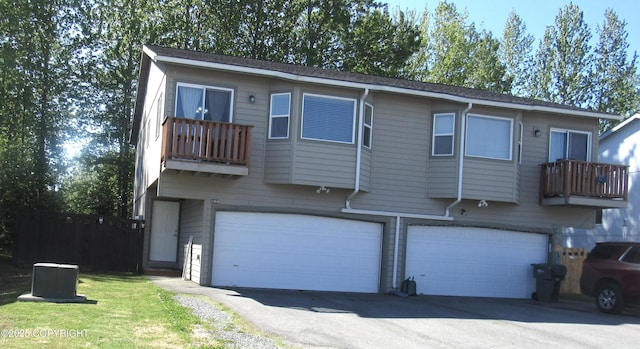 2364 Galatea Dr, Anchorage, AK 99507 - rear view of house with an attached garage, a balcony, and driveway