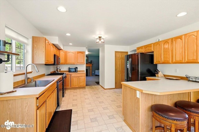 500 S Daysha Cir, Palmer, AK 99645 - kitchen featuring stainless steel appliances, a sink, a kitchen bar, a peninsula, and light flooring