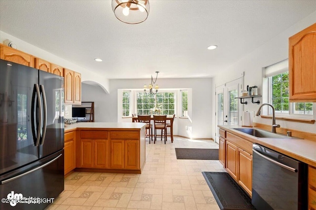 500 S Daysha Cir, Palmer, AK 99645 - kitchen featuring freestanding refrigerator, dishwasher, a sink, arched walkways, and healthy amount of natural light