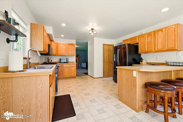 500 S Daysha Cir, Palmer, AK 99645 - kitchen featuring a peninsula, appliances with stainless steel finishes, a sink, a breakfast bar area, and baseboards