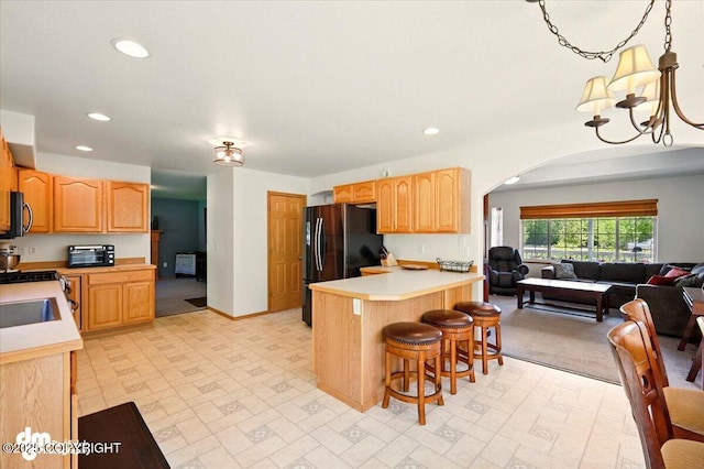 500 S Daysha Cir, Palmer, AK 99645 - kitchen featuring black appliances, arched walkways, light countertops, a breakfast bar area, and recessed lighting