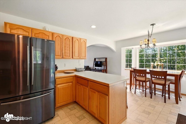 500 S Daysha Cir, Palmer, AK 99645 - kitchen with freestanding refrigerator, arched walkways, light countertops, a peninsula, and a chandelier