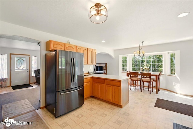 500 S Daysha Cir, Palmer, AK 99645 - kitchen featuring freestanding refrigerator, arched walkways, a peninsula, light countertops, and a chandelier