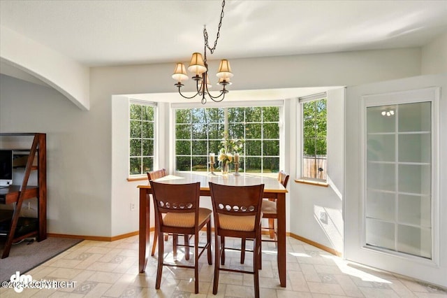 500 S Daysha Cir, Palmer, AK 99645 - dining room featuring a chandelier, healthy amount of natural light, arched walkways, and baseboards