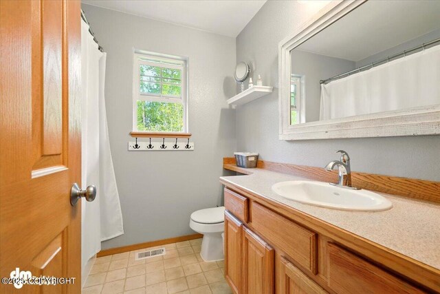 500 S Daysha Cir, Palmer, AK 99645 - full bathroom with vanity, toilet, tile patterned flooring, and baseboards