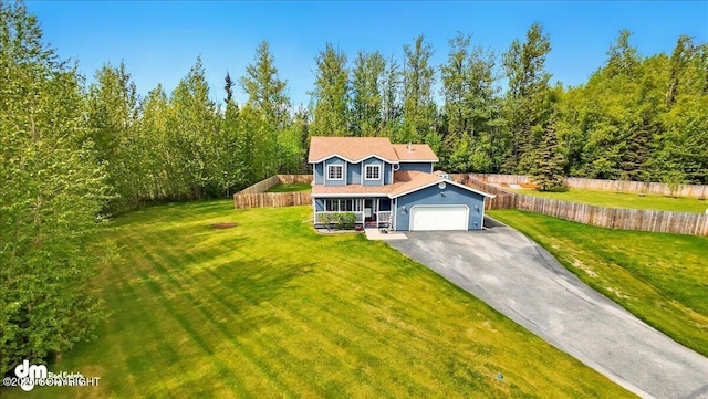 500 S Daysha Cir, Palmer, AK 99645 - traditional-style home with driveway, covered porch, a garage, and a view of trees
