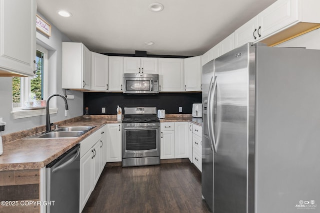 1404 Hedley Dr, Kenai, AK 99611 - kitchen with stainless steel appliances, a sink, dark wood-type flooring, white cabinets, and recessed lighting