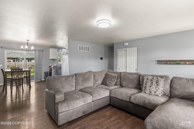 1404 Hedley Dr, Kenai, AK 99611 - living room with a chandelier and dark wood-style flooring