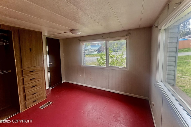 450 Noview Ave, Homer, AK 99603 - unfurnished bedroom with baseboards and wood walls