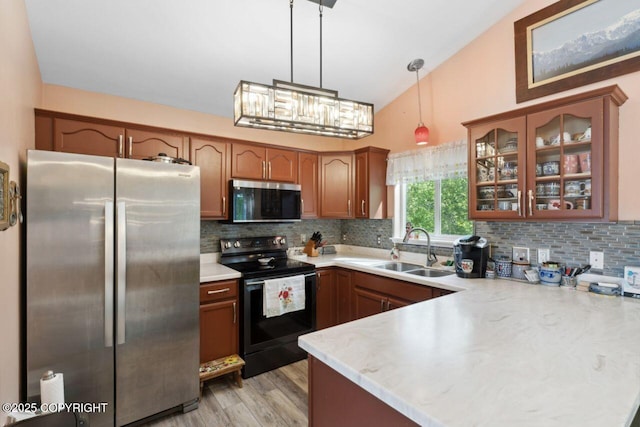 4245 Scenic View Dr, Anchorage, AK 99504 - kitchen featuring stainless steel appliances, a sink, a peninsula, light countertops, and lofted ceiling