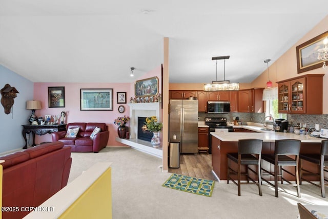 4245 Scenic View Dr, Anchorage, AK 99504 - kitchen with stainless steel appliances, a peninsula, light countertops, a sink, and open floor plan