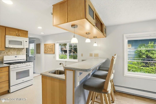 2527 Cottonwood St, Anchorage, AK 99508 - kitchen featuring white appliances, baseboard heating, tasteful backsplash, a breakfast bar area, and a peninsula