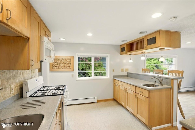 2527 Cottonwood St, Anchorage, AK 99508 - kitchen featuring white appliances, a sink, a baseboard heating unit, a peninsula, and plenty of natural light