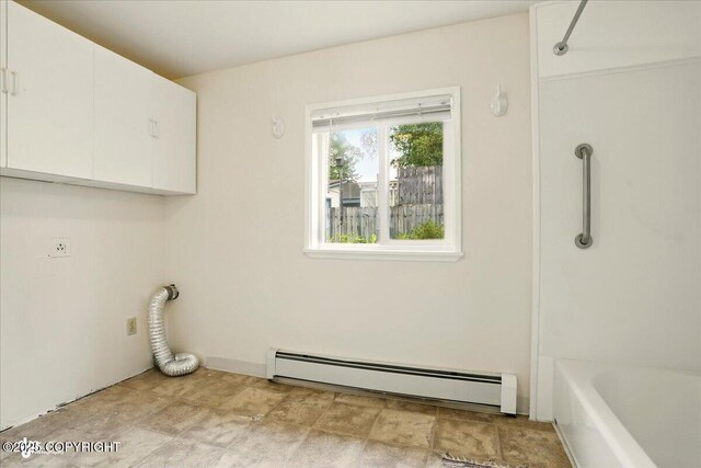 2527 Cottonwood St, Anchorage, AK 99508 - laundry room with a baseboard radiator, cabinet space, and hookup for an electric dryer
